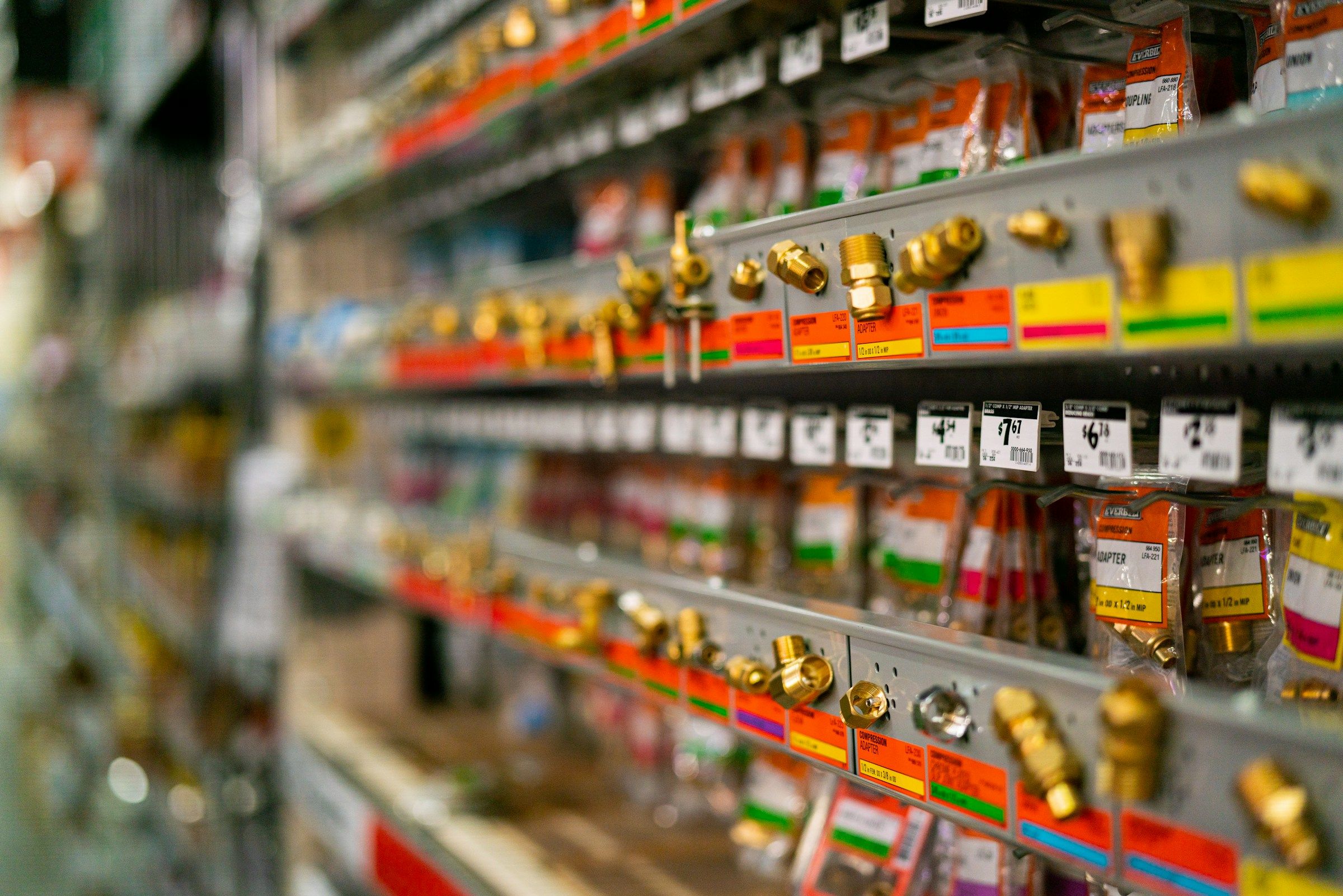 Brightly stocked retail shelves with hanging products
